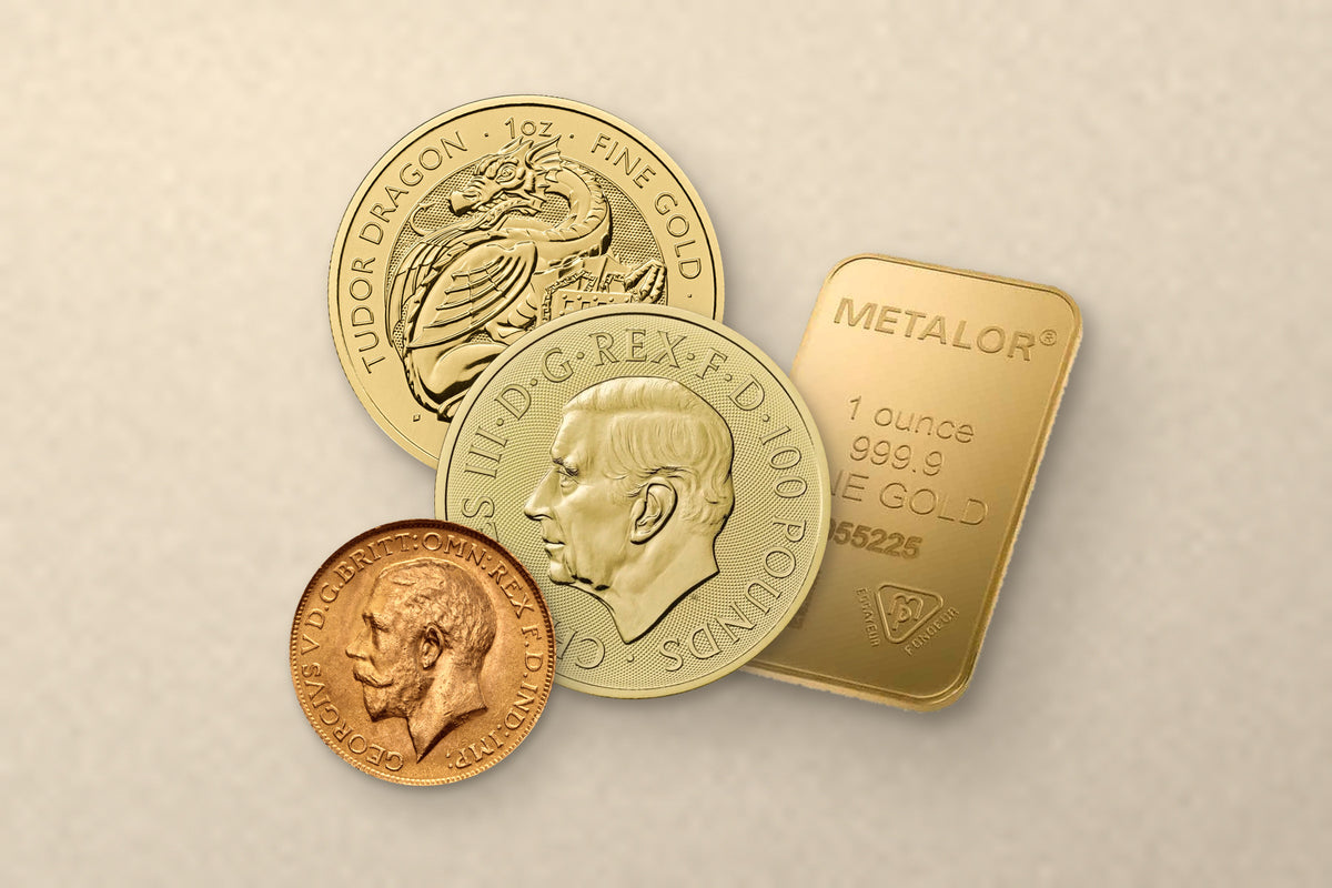 Gold from the catalogue on warm cream stone: a one ounce Tudor Beasts dragon coin, a one ounce gold coin bearing the King Charles III portrait, a George V sovereign and a Metalor one ounce fine gold bar